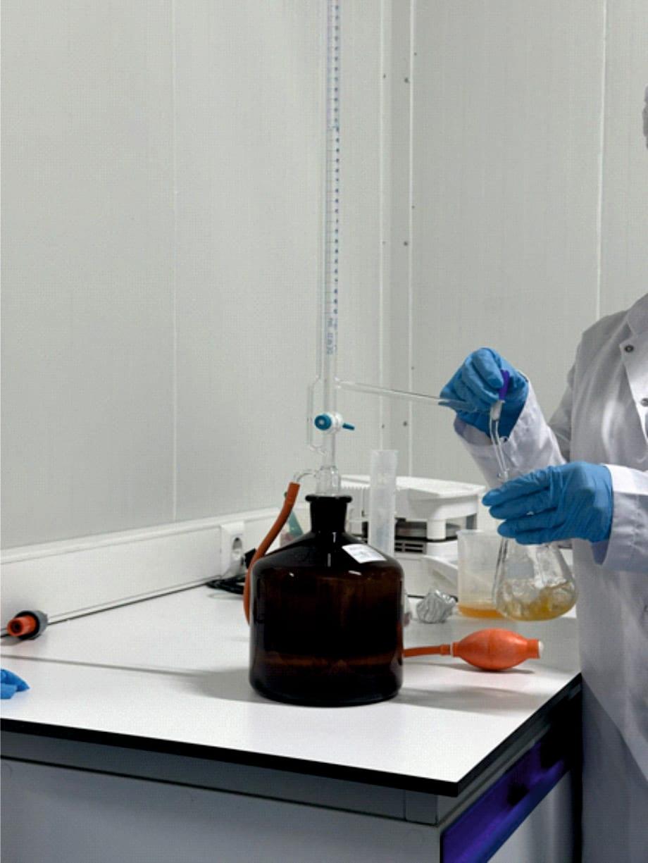Laboratory technician performing titration analysis